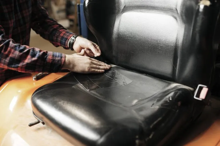 Black duct tape placed to cover up the rips on a vehicles seat.